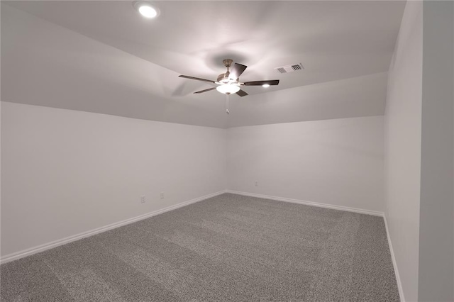 carpeted empty room featuring ceiling fan and vaulted ceiling