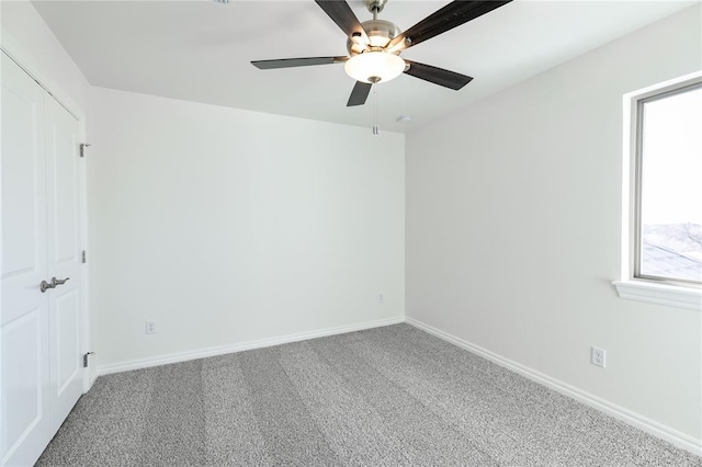 spare room with carpet and ceiling fan