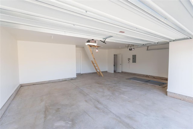 garage with electric panel and a garage door opener