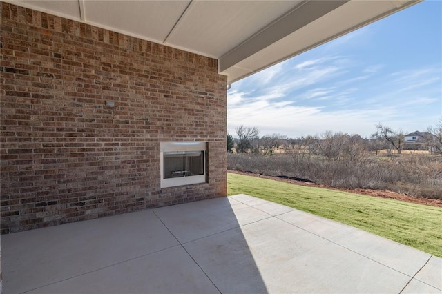 view of patio featuring an outdoor brick fireplace