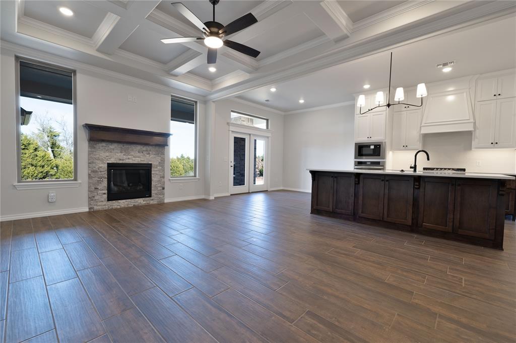 kitchen with built in microwave, white cabinetry, dark hardwood / wood-style floors, and ornamental molding