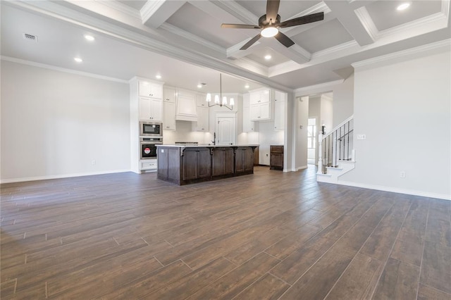 unfurnished living room featuring ornamental molding, coffered ceiling, ceiling fan with notable chandelier, dark wood-type flooring, and beamed ceiling