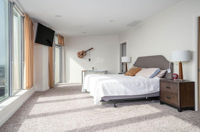 bedroom featuring light carpet