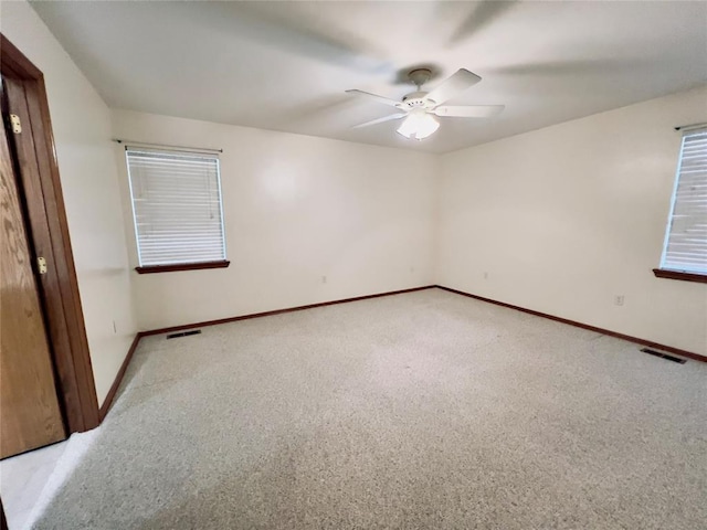 unfurnished room with ceiling fan and light carpet