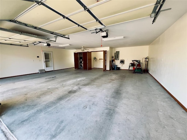 garage with ceiling fan, electric panel, and a garage door opener