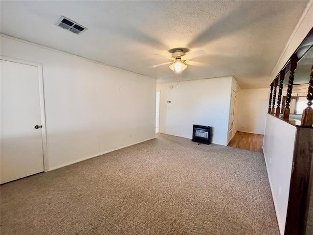 interior space featuring ceiling fan, a textured ceiling, and heating unit