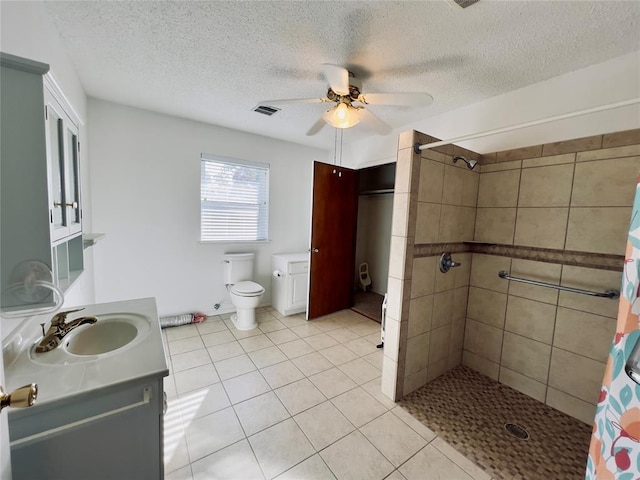 bathroom with a shower with shower curtain, a textured ceiling, and tile patterned floors