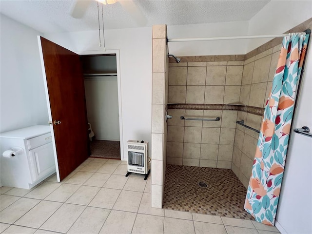 bathroom featuring tile patterned flooring, a textured ceiling, walk in shower, and heating unit