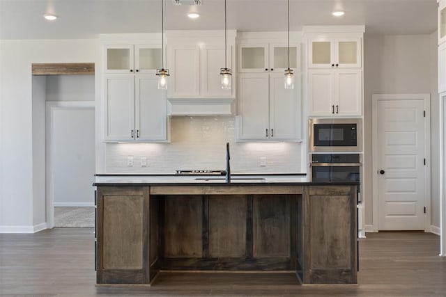 kitchen featuring white cabinets, sink, an island with sink, and appliances with stainless steel finishes