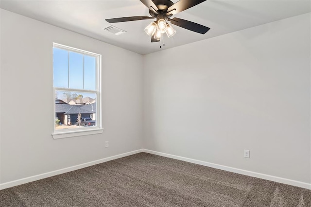 carpeted spare room featuring ceiling fan