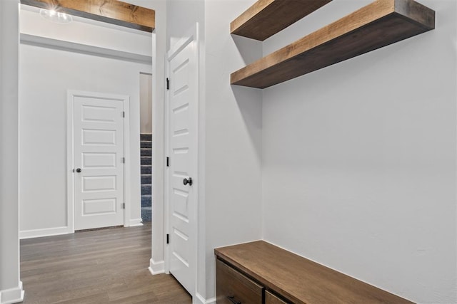 mudroom with beam ceiling and dark hardwood / wood-style floors