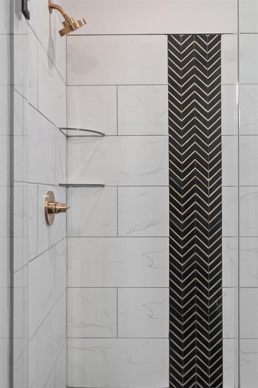 bathroom with tiled shower