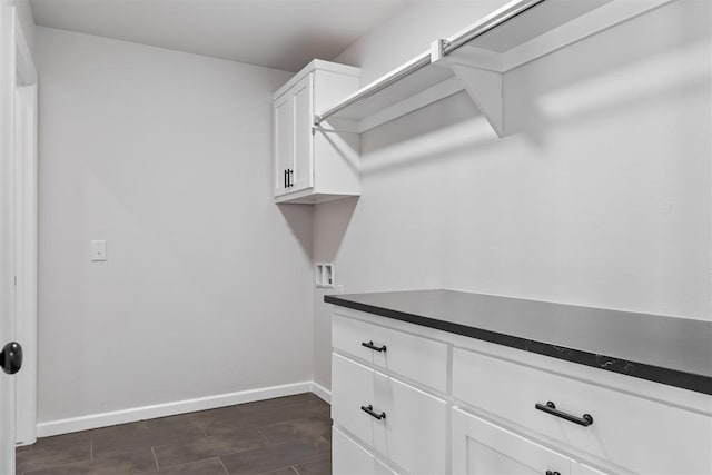 washroom featuring hookup for a washing machine and cabinets