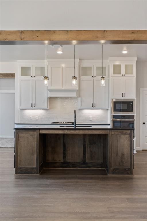 13268 Sawtooth Oak Rd, Choctaw, OK 73020 - kitchen featuring appliances with stainless steel finishes, white cabinets, decorative backsplash, and wood finished floors