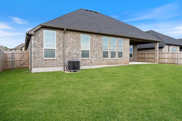 13268 Sawtooth Oak Rd, Choctaw, OK 73020 - rear view of property featuring a fenced backyard, brick siding, and a shingled roof