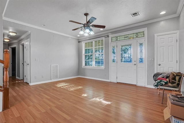 foyer entrance featuring light wood-type flooring, ceiling fan, and ornamental molding