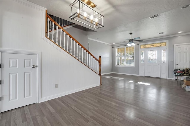 entrance foyer with wood-type flooring, ceiling fan with notable chandelier, and a textured ceiling