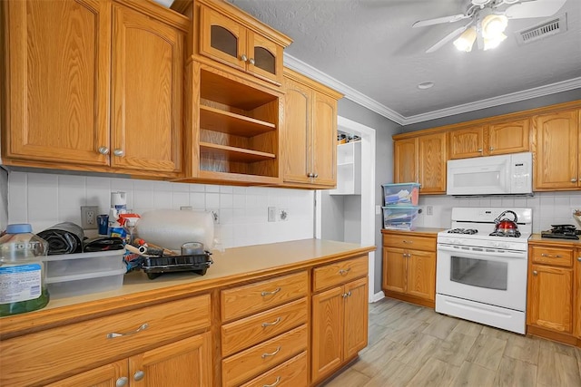 kitchen with ceiling fan, light hardwood / wood-style flooring, backsplash, white appliances, and ornamental molding