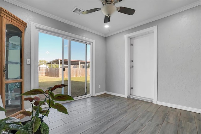 empty room with crown molding, ceiling fan, and light wood-type flooring