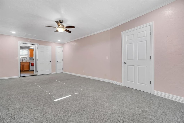 empty room with carpet flooring, ceiling fan, and ornamental molding