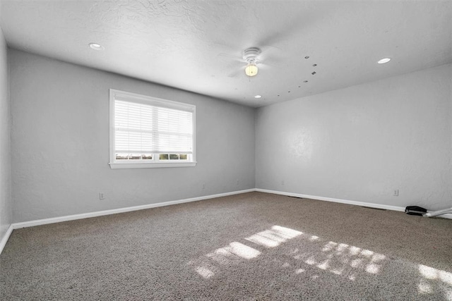 unfurnished room featuring ceiling fan and carpet floors