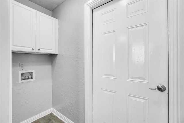 clothes washing area featuring cabinets and washer hookup