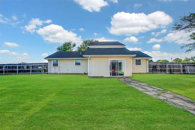 rear view of house with a yard