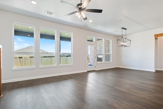 interior space with dark hardwood / wood-style flooring and plenty of natural light