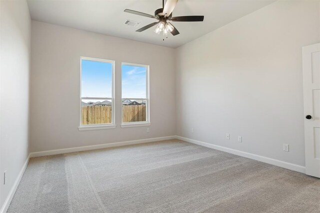 empty room featuring ceiling fan and light colored carpet