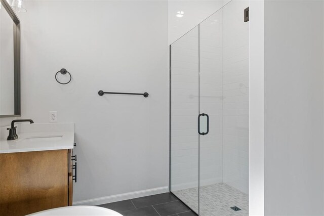 bathroom featuring tile patterned floors, vanity, and an enclosed shower