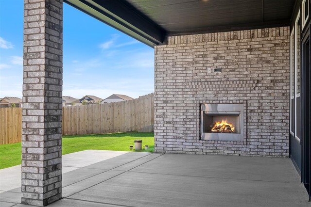 view of patio / terrace with an outdoor brick fireplace