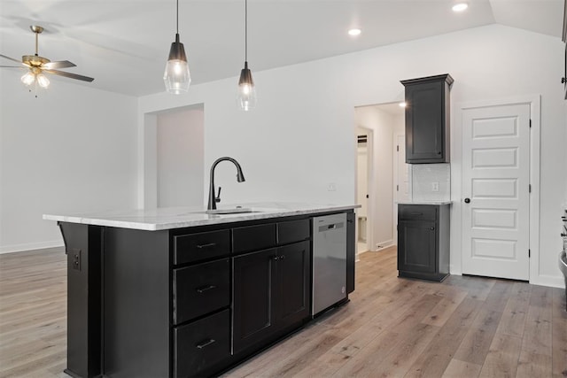 kitchen with stainless steel dishwasher, ceiling fan, sink, a center island with sink, and light hardwood / wood-style floors