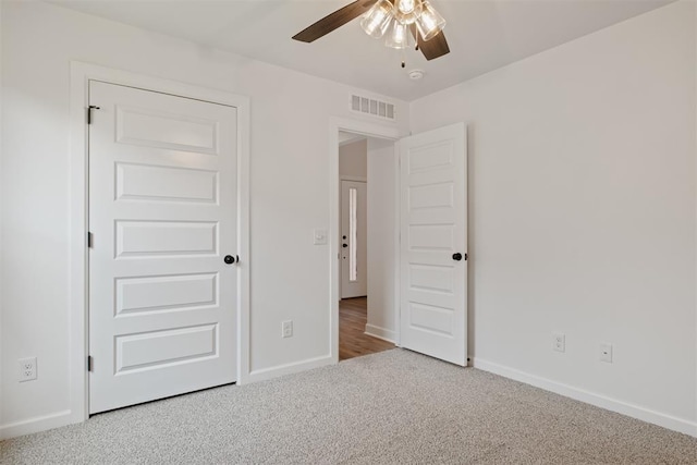 unfurnished bedroom with carpet floors and ceiling fan