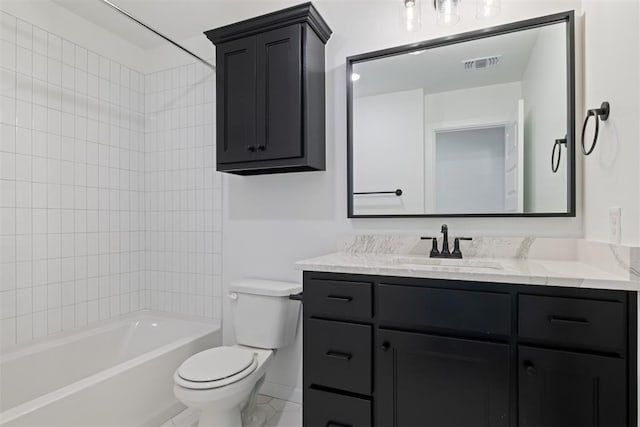 full bathroom featuring tiled shower / bath, vanity, and toilet