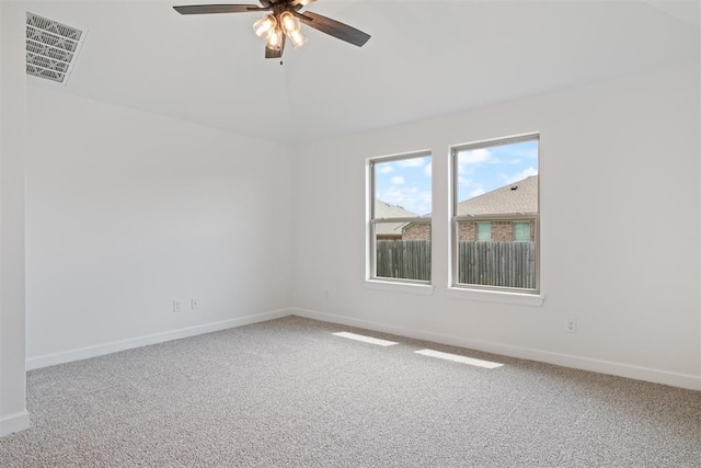 spare room featuring ceiling fan and carpet