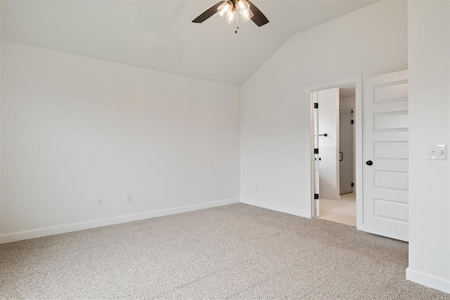 carpeted empty room featuring ceiling fan and vaulted ceiling