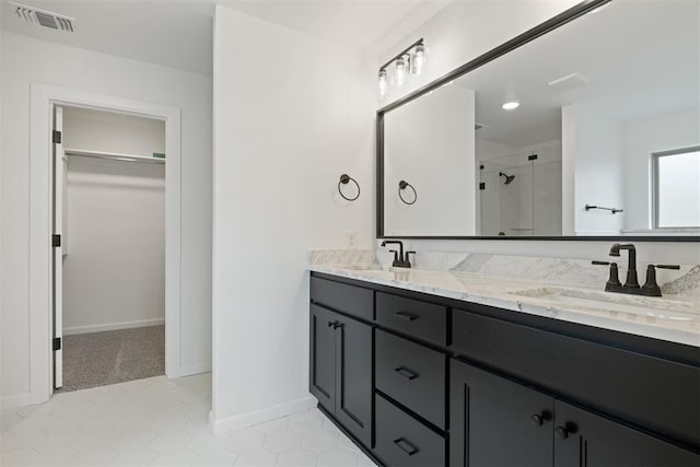 bathroom featuring vanity, tile patterned floors, and a shower with shower door