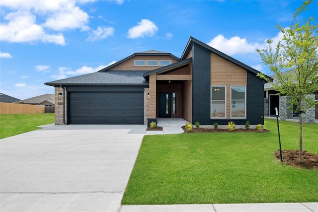 view of front of home featuring a garage and a front lawn