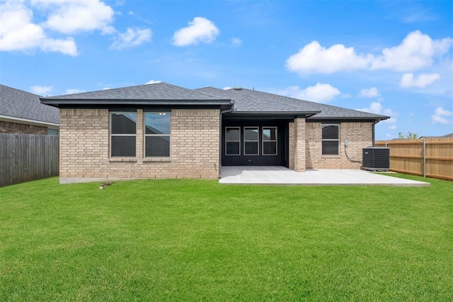 rear view of house featuring a lawn, a patio, and central AC unit