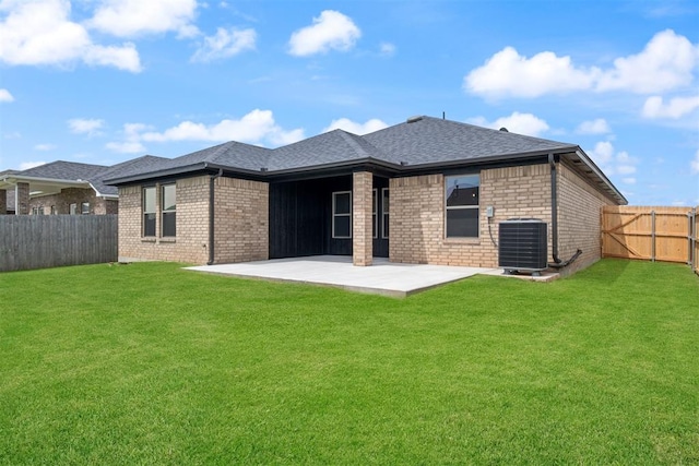 back of house featuring a lawn, cooling unit, and a patio