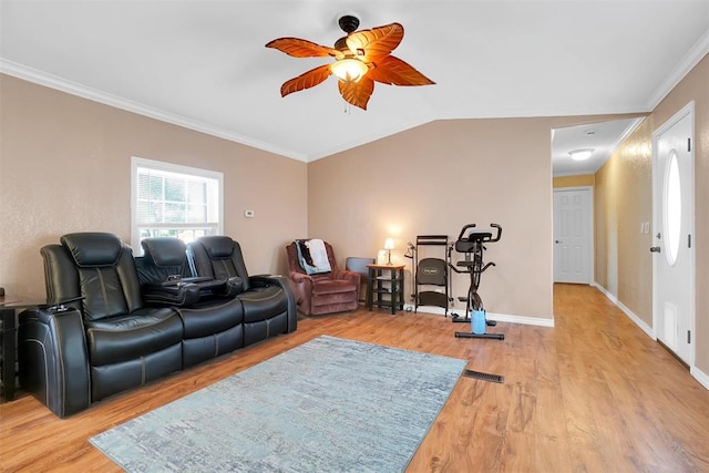 living room with ceiling fan, ornamental molding, vaulted ceiling, and light wood-type flooring