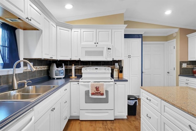 kitchen with lofted ceiling, white cabinetry, white appliances, and sink