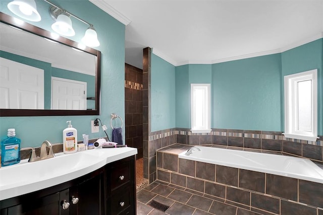 bathroom featuring a relaxing tiled tub, a healthy amount of sunlight, and crown molding