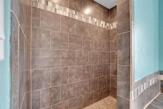 bathroom with a tile shower