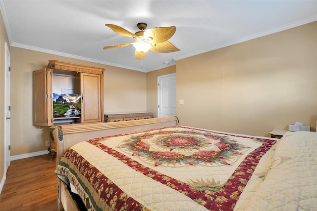 bedroom with ceiling fan, wood-type flooring, and crown molding