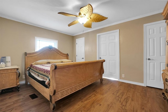 bedroom with ornamental molding, ceiling fan, and dark wood-type flooring