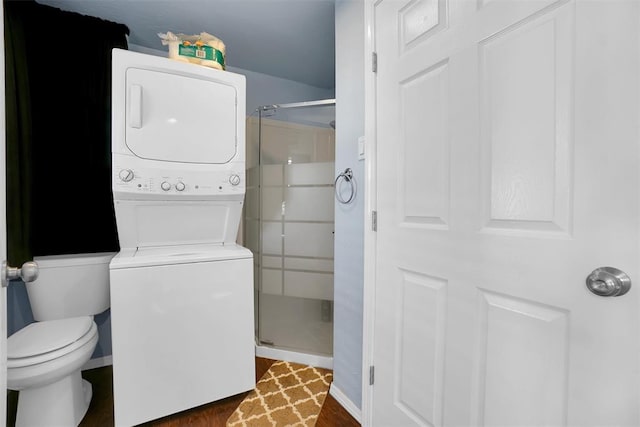 laundry room featuring stacked washer / dryer and dark wood-type flooring