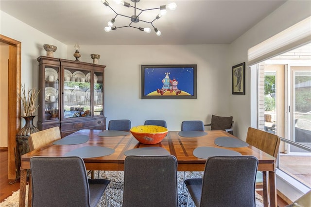 dining room with hardwood / wood-style floors and a notable chandelier
