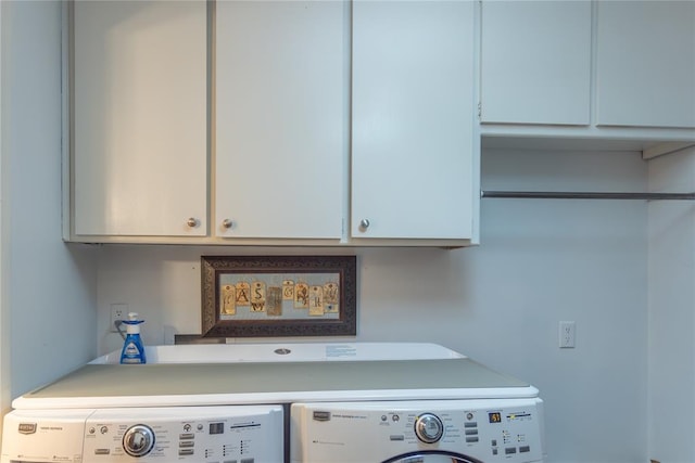 clothes washing area with cabinets and washing machine and dryer