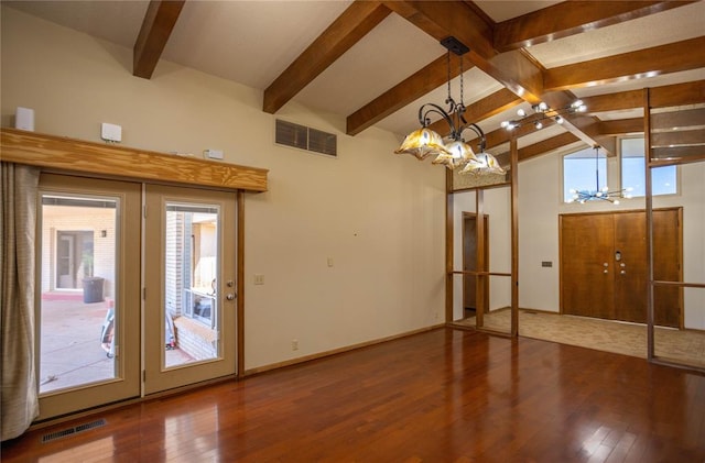 interior space featuring hardwood / wood-style floors, lofted ceiling with beams, and a notable chandelier
